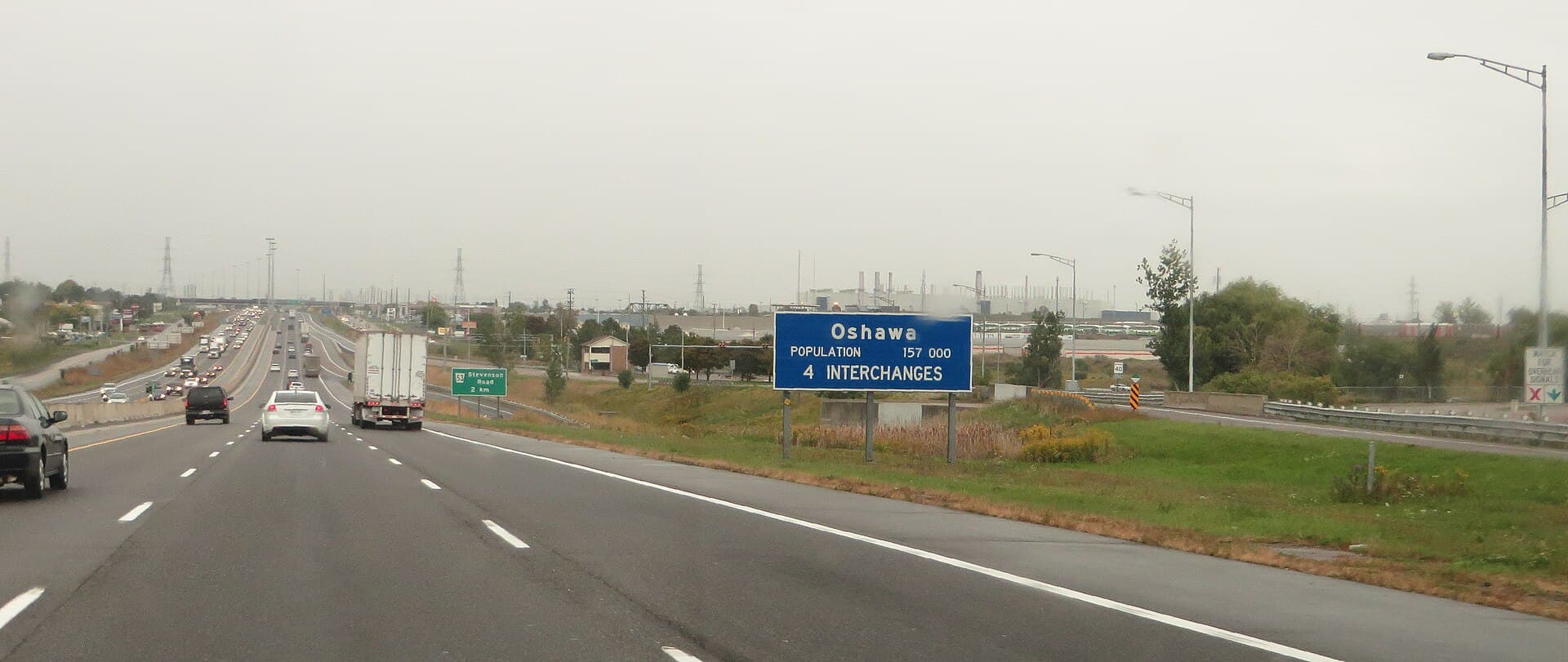 Highway 401 traffic approaching the Oshawa city limits sign in Durham Region, Ontario